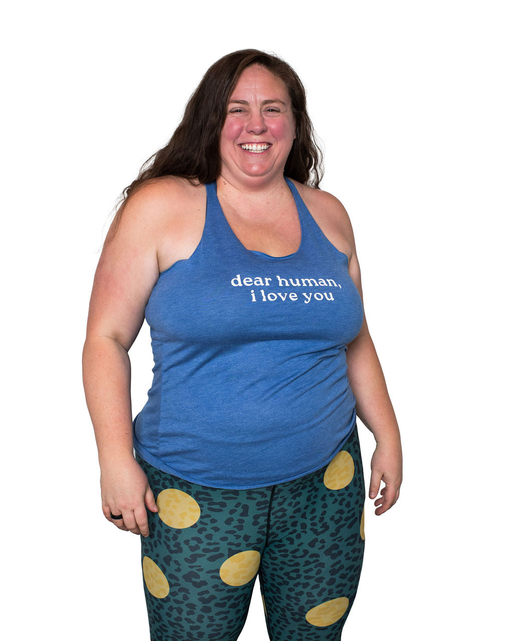 Mackenzie wearing a blue tank top with text saying "Dear Human, I Love You and green leggings with gold polka dots on a white background