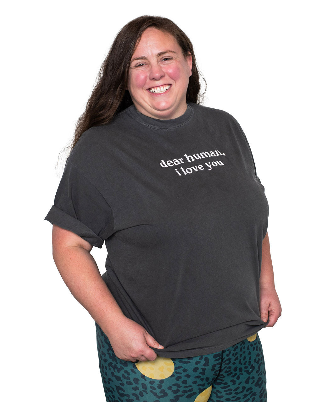 Mackenzie wearing a dark gray t-shirt with 'dear human, i love you' text on a white background.