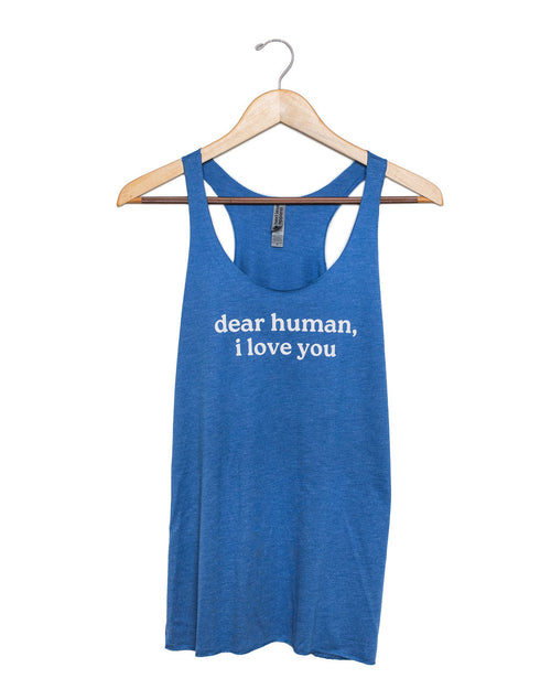 Blue tank top with 'dear human, i love you' text on a hanger against a white background
