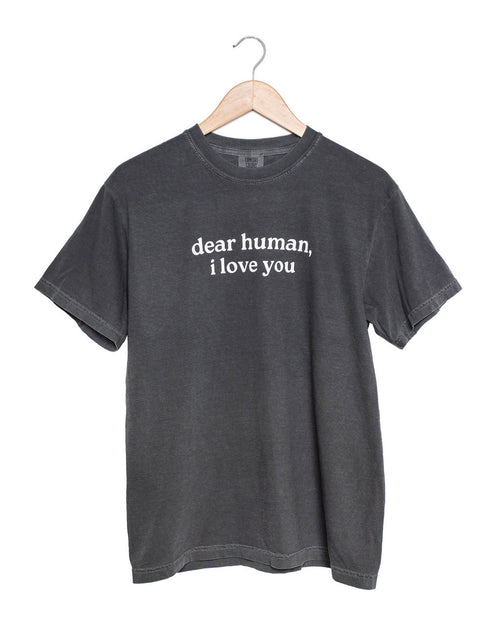 Gray t-shirt with 'dear human, i love you' text on a hanger against a white background